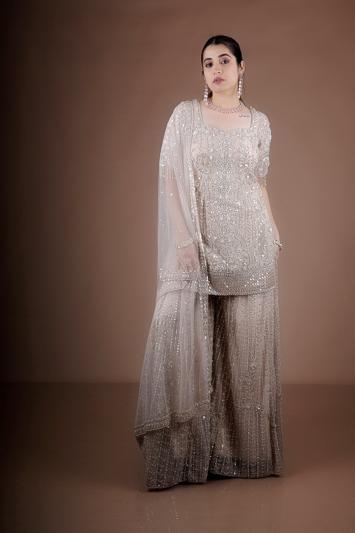 Peach Sharara suit adorned with hand embroidery