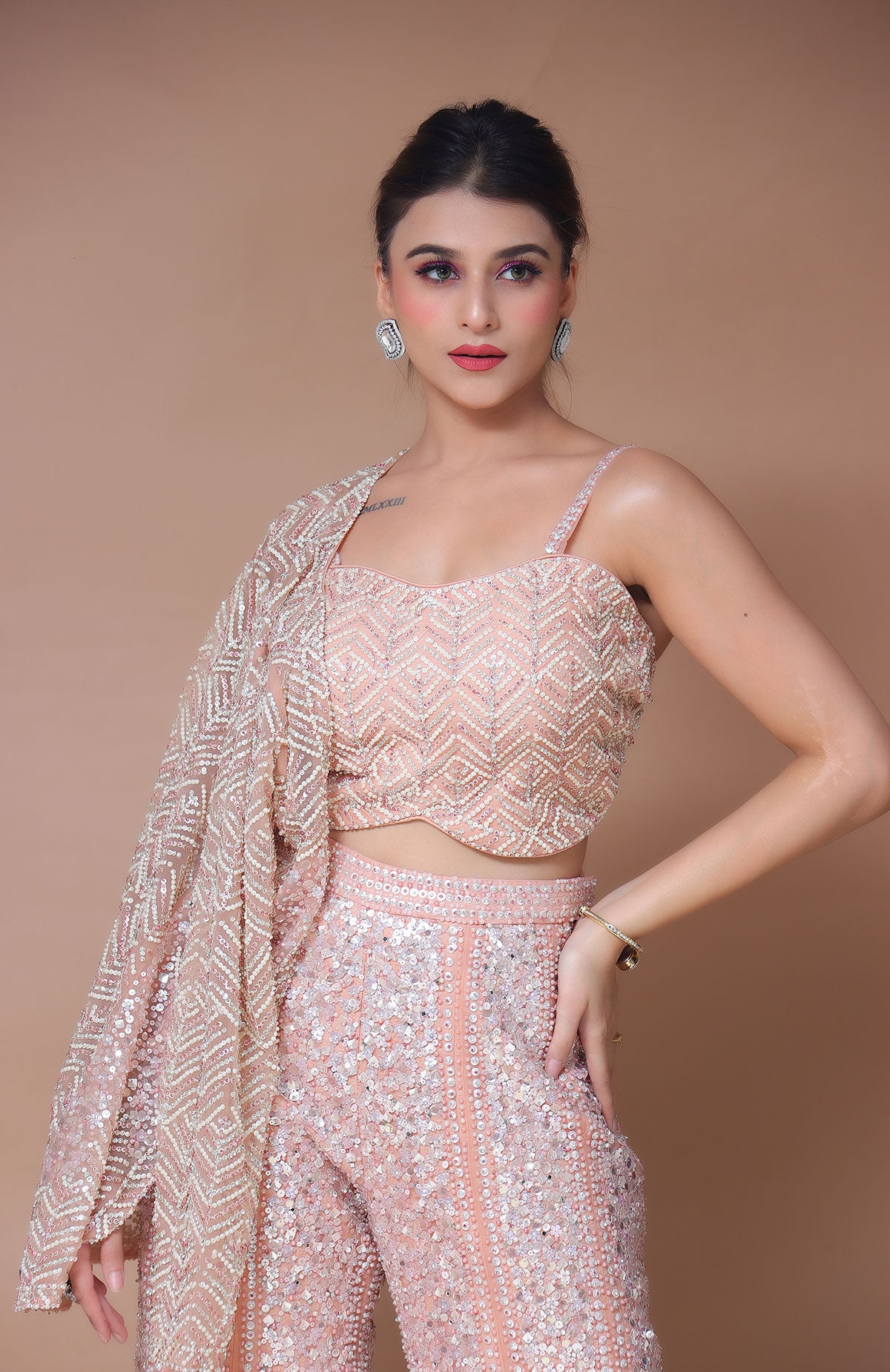 Peach Sharara Suit along with jacket and dupatta in net having heavy embroidery