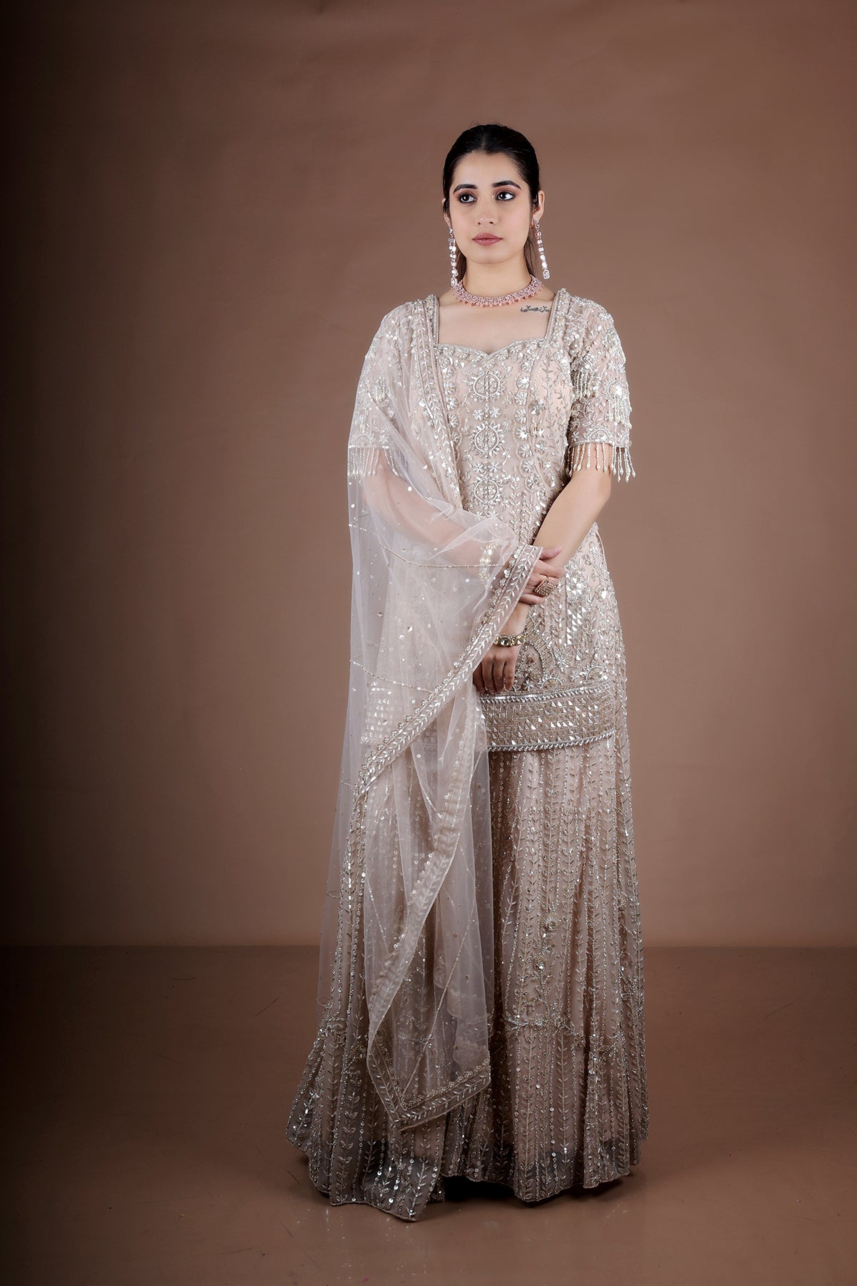 Peach Sharara suit adorned with hand embroidery
