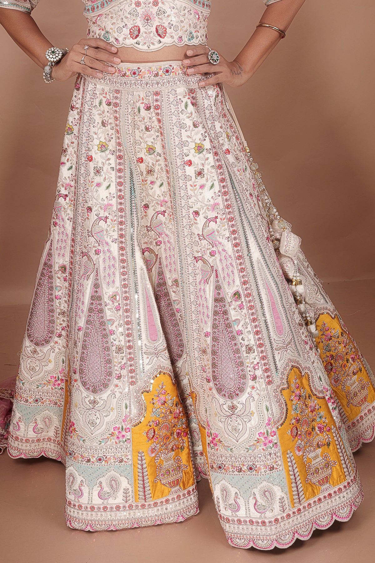 White Lehenga adorned with intricate embroidery and beads, making it an elegant and eye-catching piece