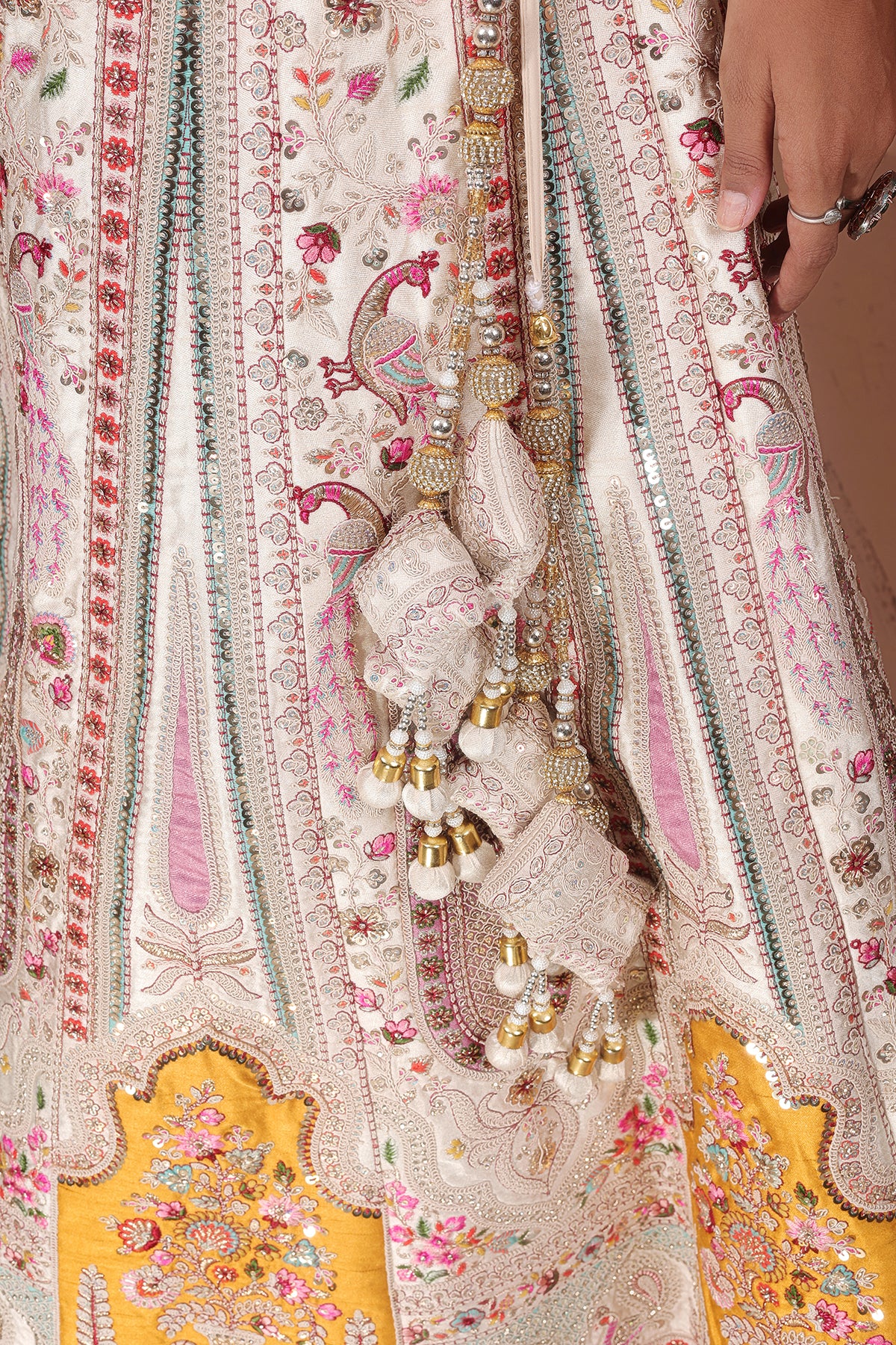 White Lehenga adorned with intricate embroidery and beads, making it an elegant and eye-catching piece