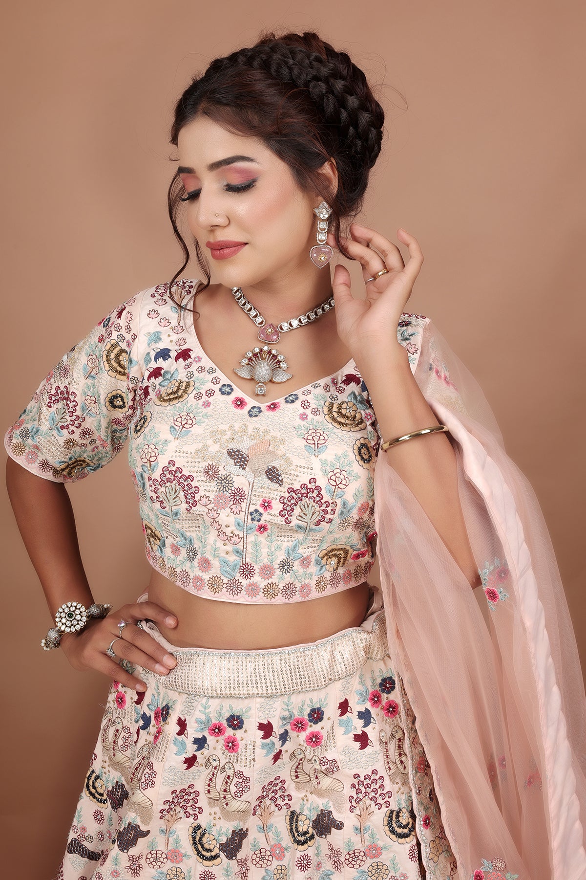 White and Pink Lehenga adorned with intricate embroidery and beads, making it an elegant and eye-catching piece