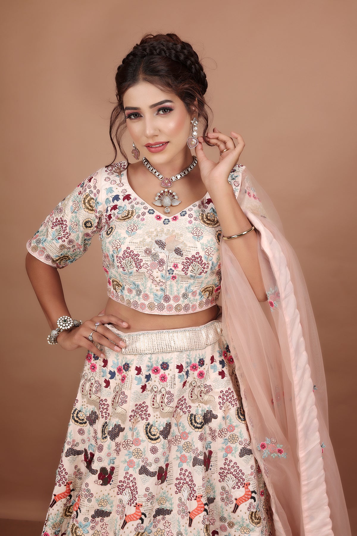 White and Pink Lehenga adorned with intricate embroidery and beads, making it an elegant and eye-catching piece