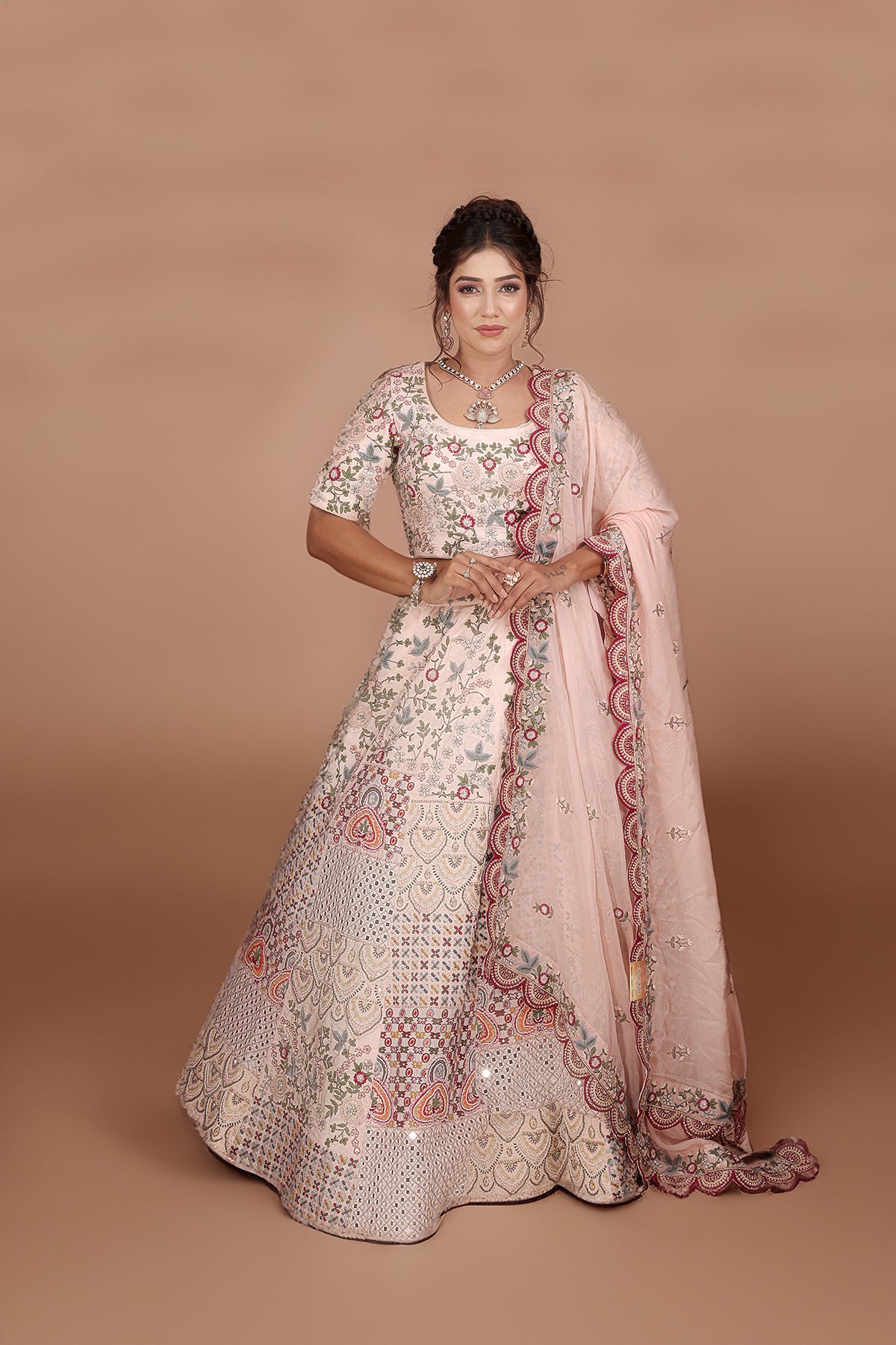 Peach and Pink Lehenga adorned with intricate embroidery and beads, making it an elegant and eye-catching piece