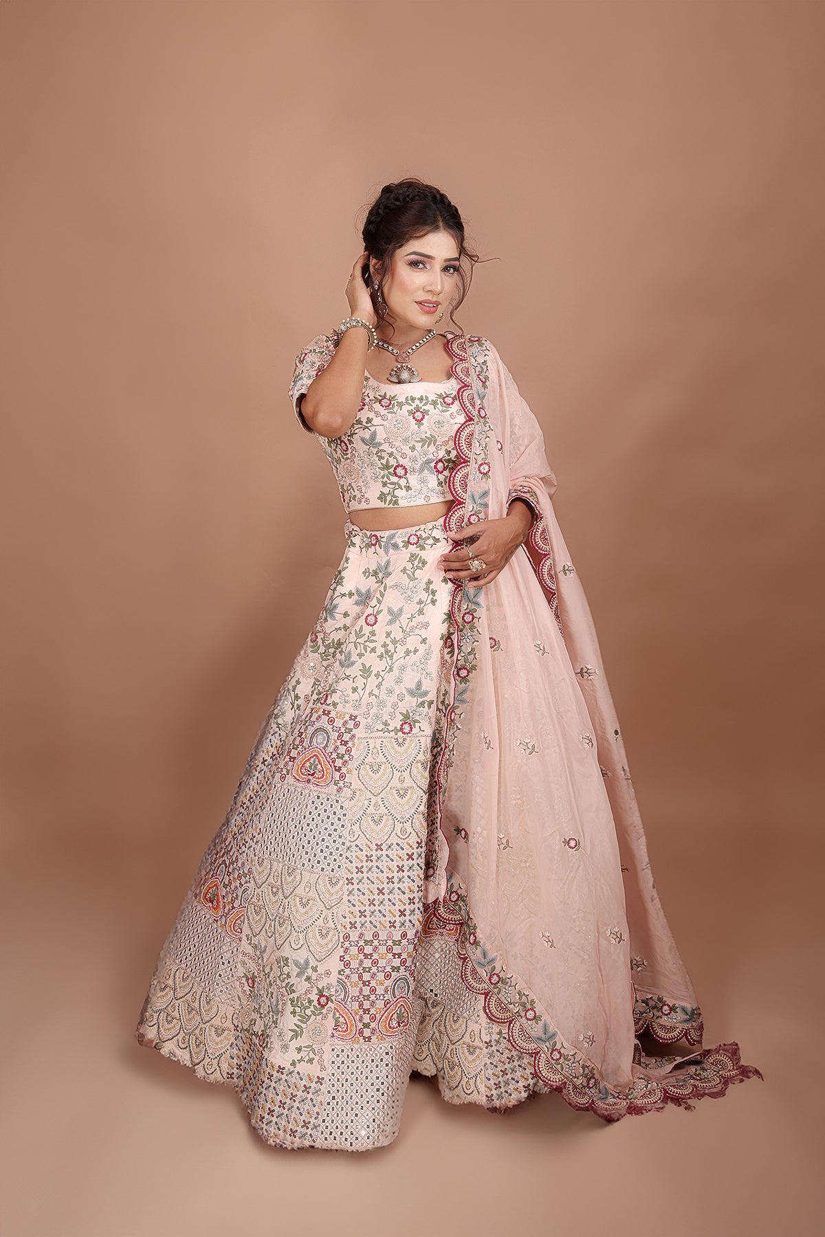 Peach and Pink Lehenga adorned with intricate embroidery and beads, making it an elegant and eye-catching piece