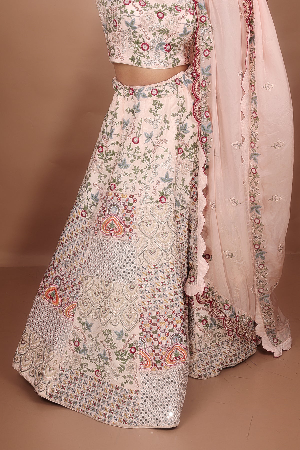 Peach and Pink Lehenga adorned with intricate embroidery and beads, making it an elegant and eye-catching piece