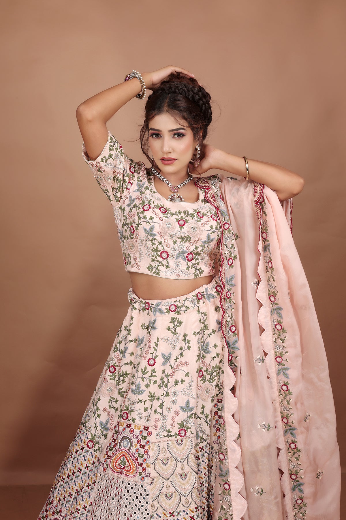 Peach and Pink Lehenga adorned with intricate embroidery and beads, making it an elegant and eye-catching piece