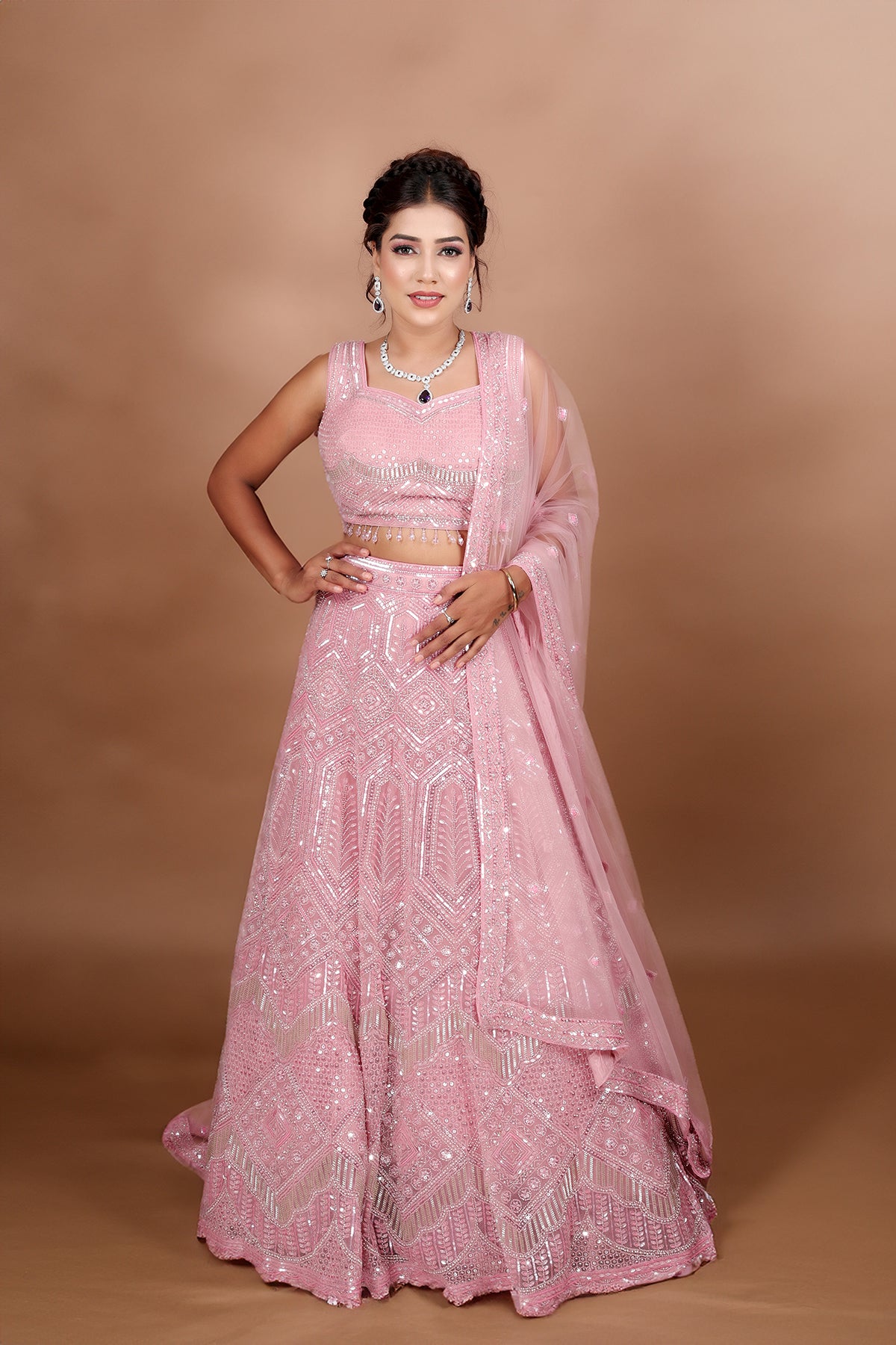 Blush pink Lehenga in Net fabric adorned with thread, pearl and cut dana embroidery