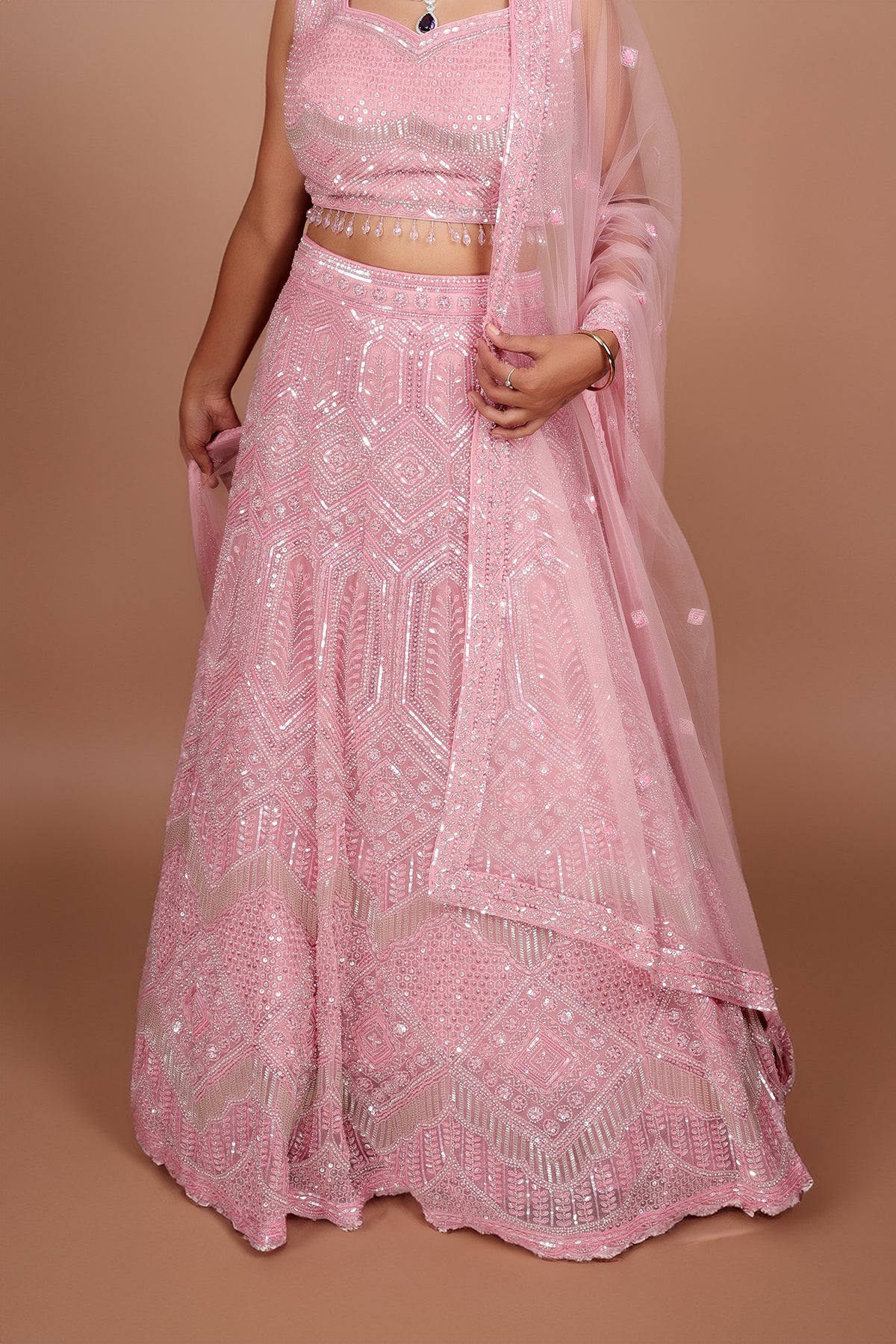 Blush pink Lehenga in Net fabric adorned with thread, pearl and cut dana embroidery