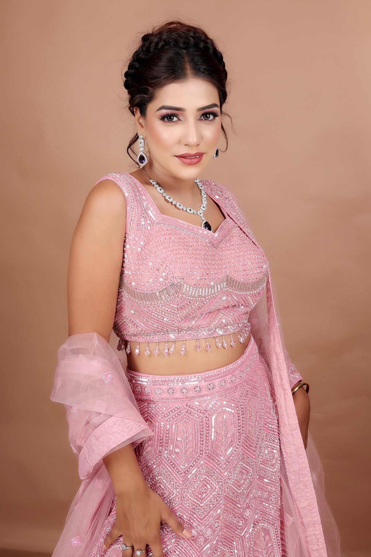 Blush pink Lehenga in Net fabric adorned with thread, pearl and cut dana embroidery