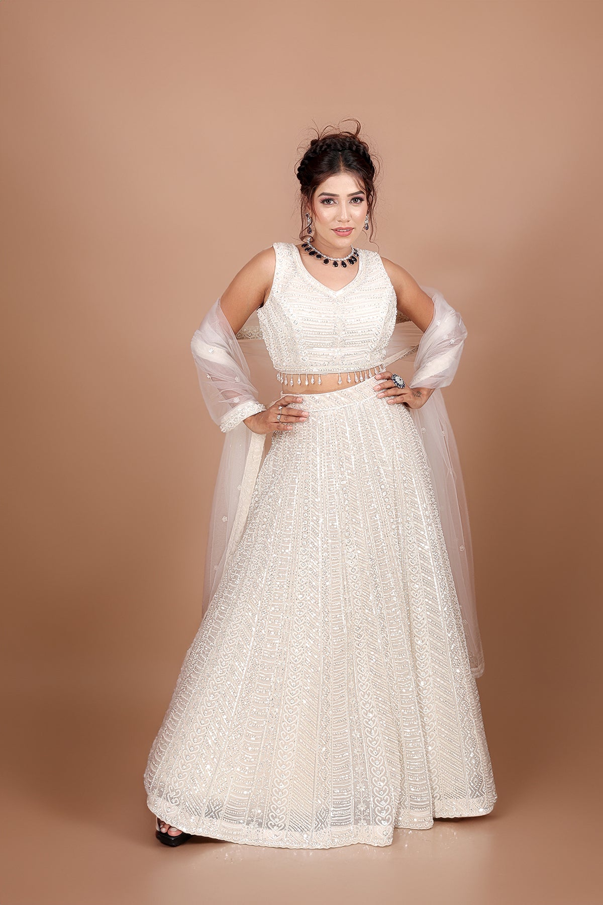 White Lehenga in Net fabric adorned with thread, pearl and cut dana embroidery