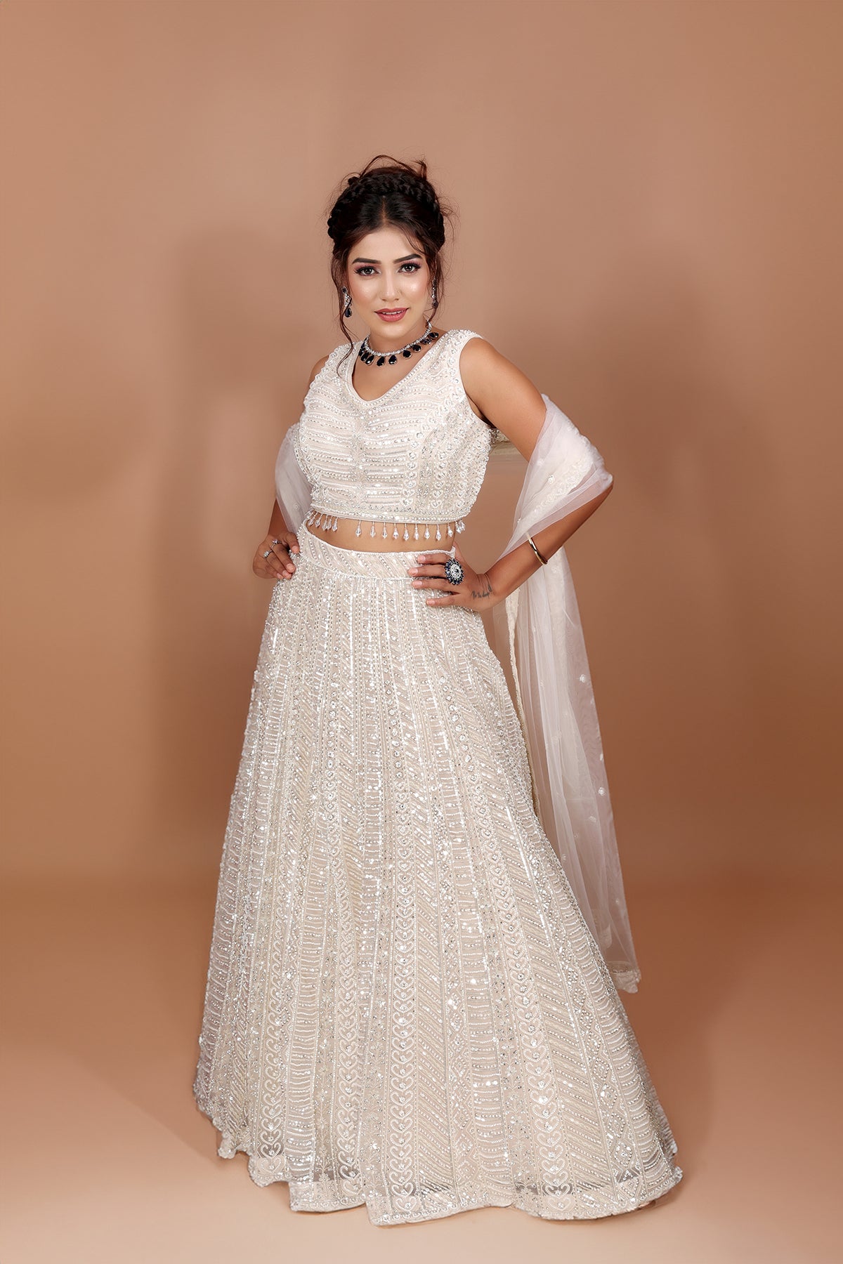 White Lehenga in Net fabric adorned with thread, pearl and cut dana embroidery