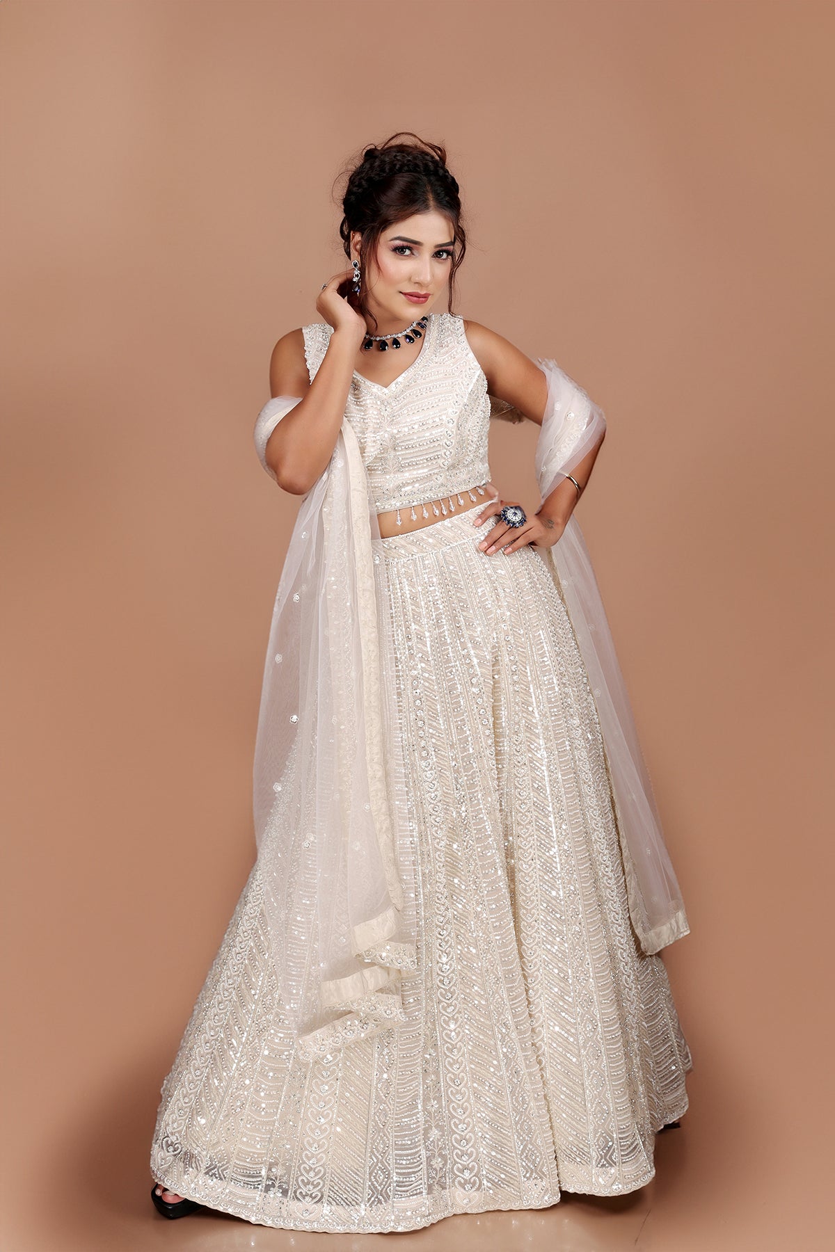 White Lehenga in Net fabric adorned with thread, pearl and cut dana embroidery