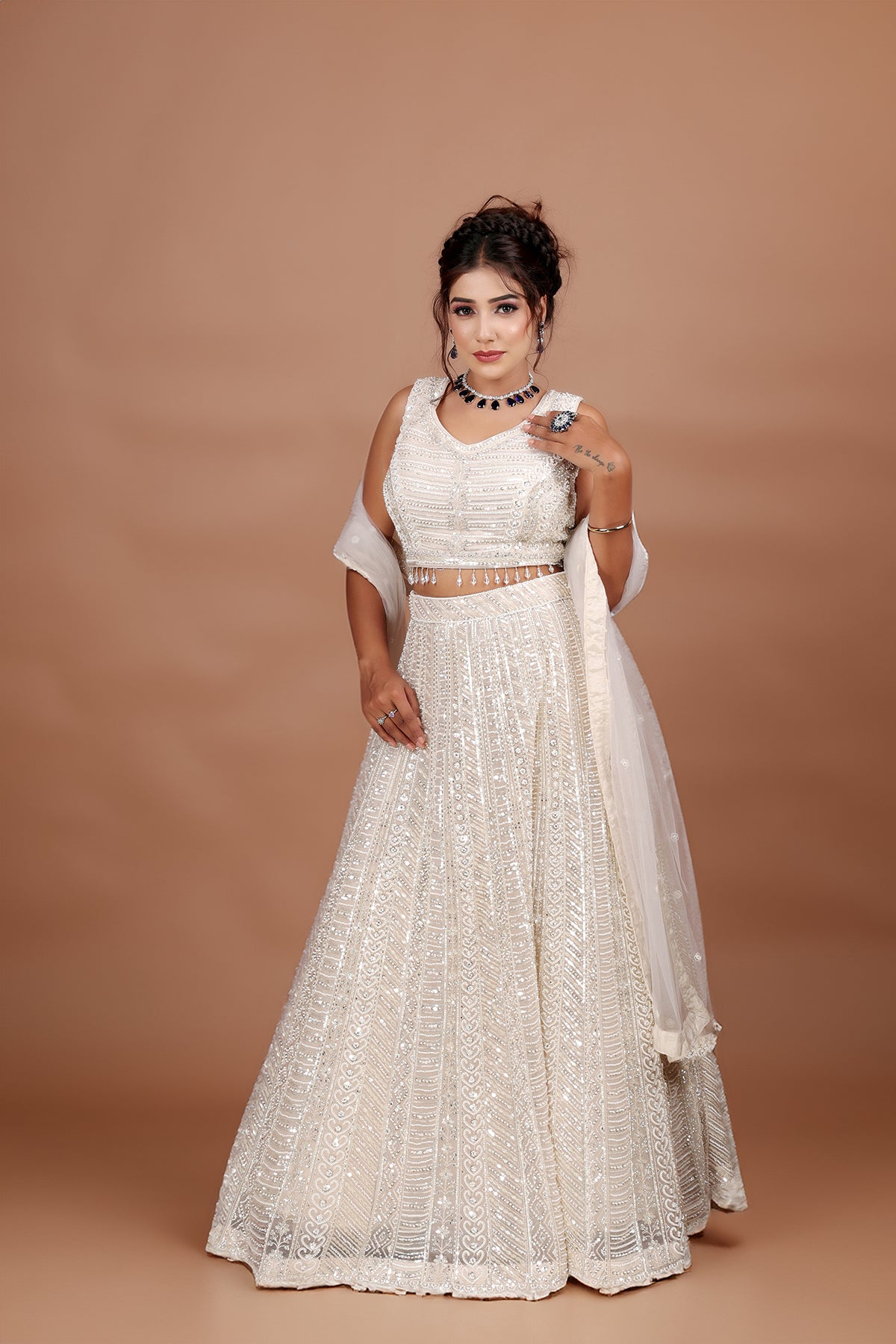 White Lehenga in Net fabric adorned with thread, pearl and cut dana embroidery