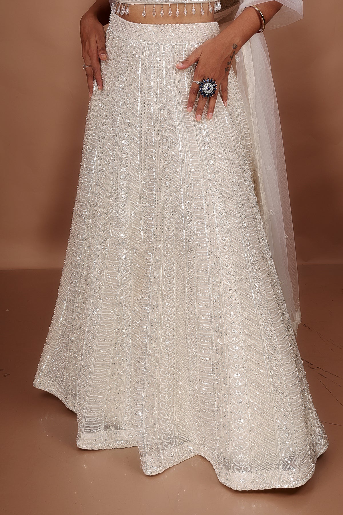 White Lehenga in Net fabric adorned with thread, pearl and cut dana embroidery