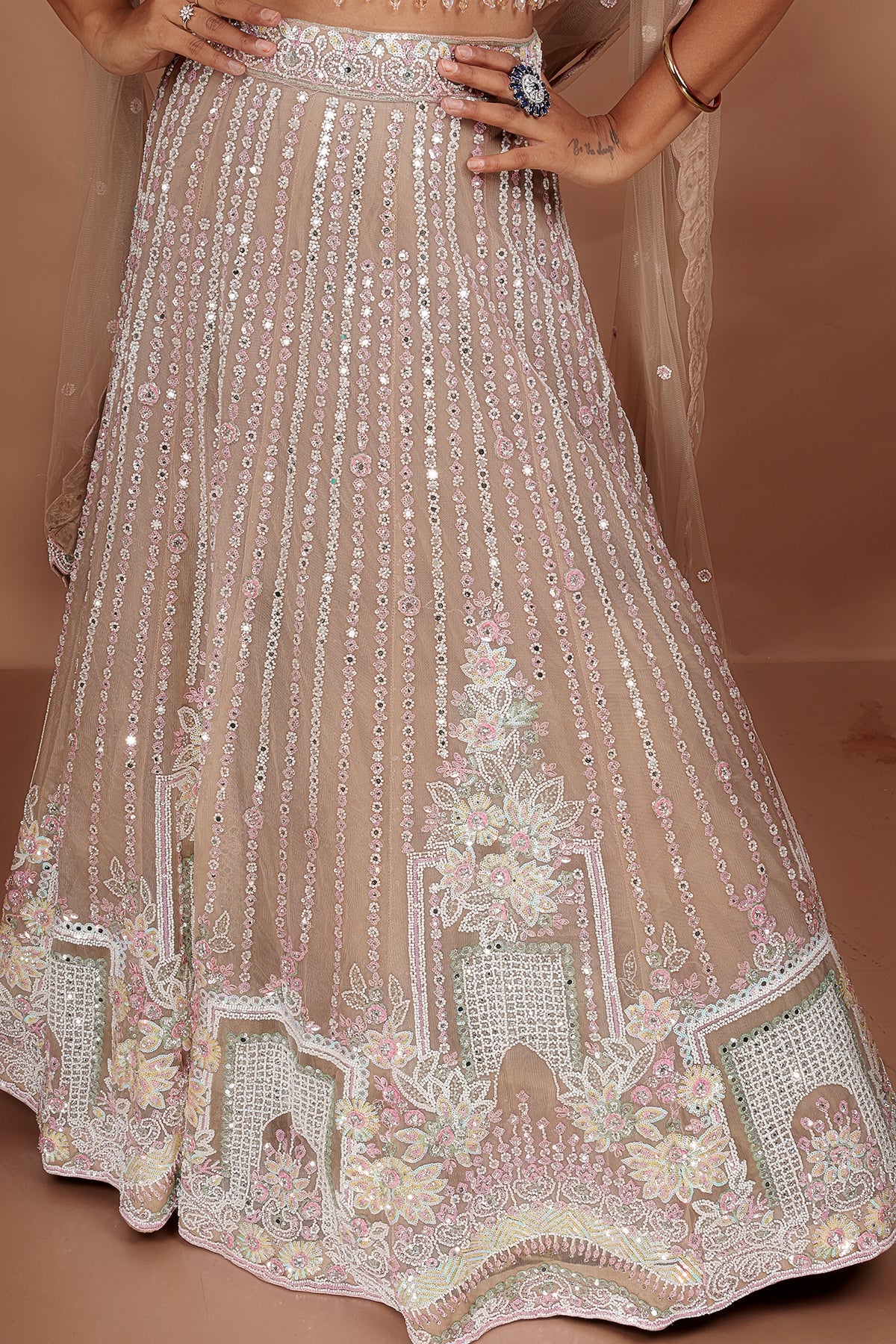 Beige Lehenga in Net fabric adorned with thread, pearl and cut dana embroidery