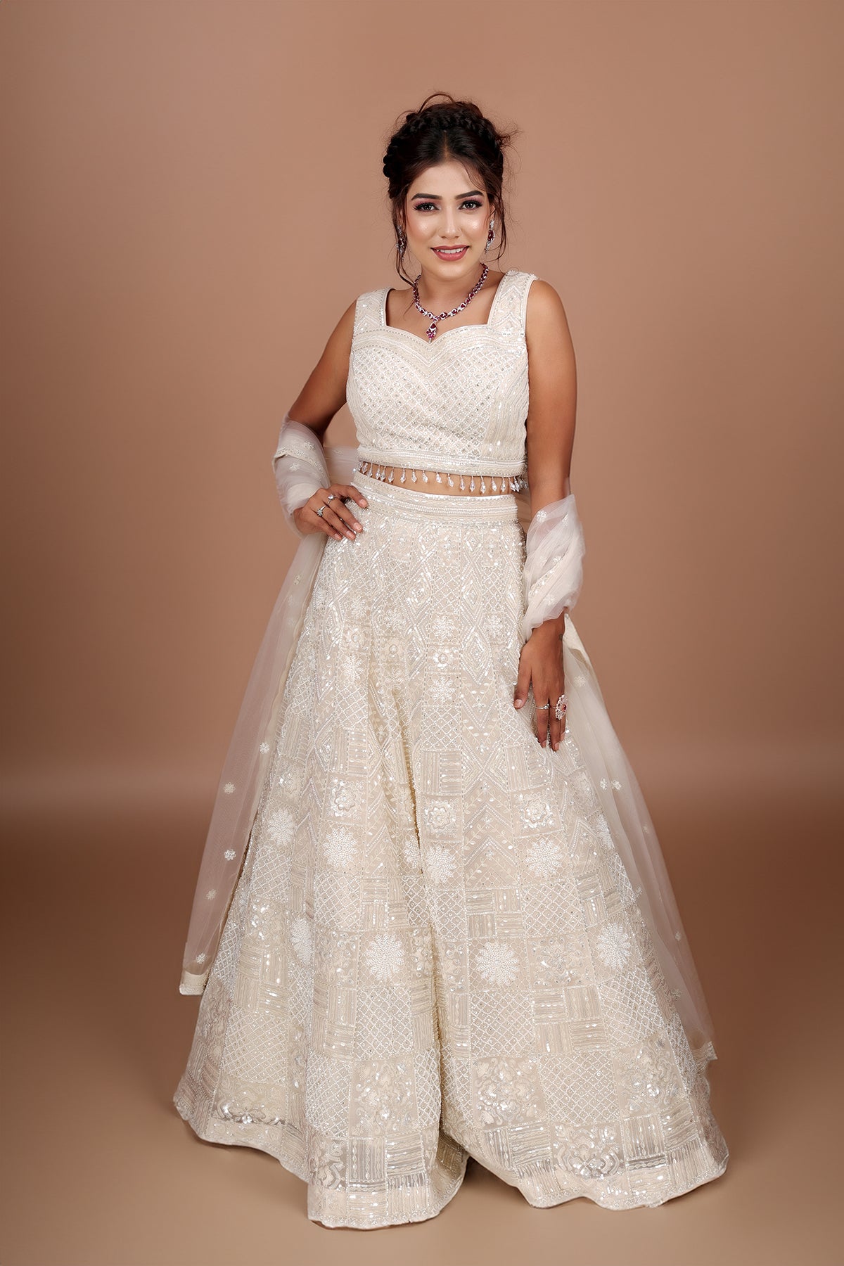 White Lehenga in Net fabric adorned with thread, pearl and cut dana embroidery