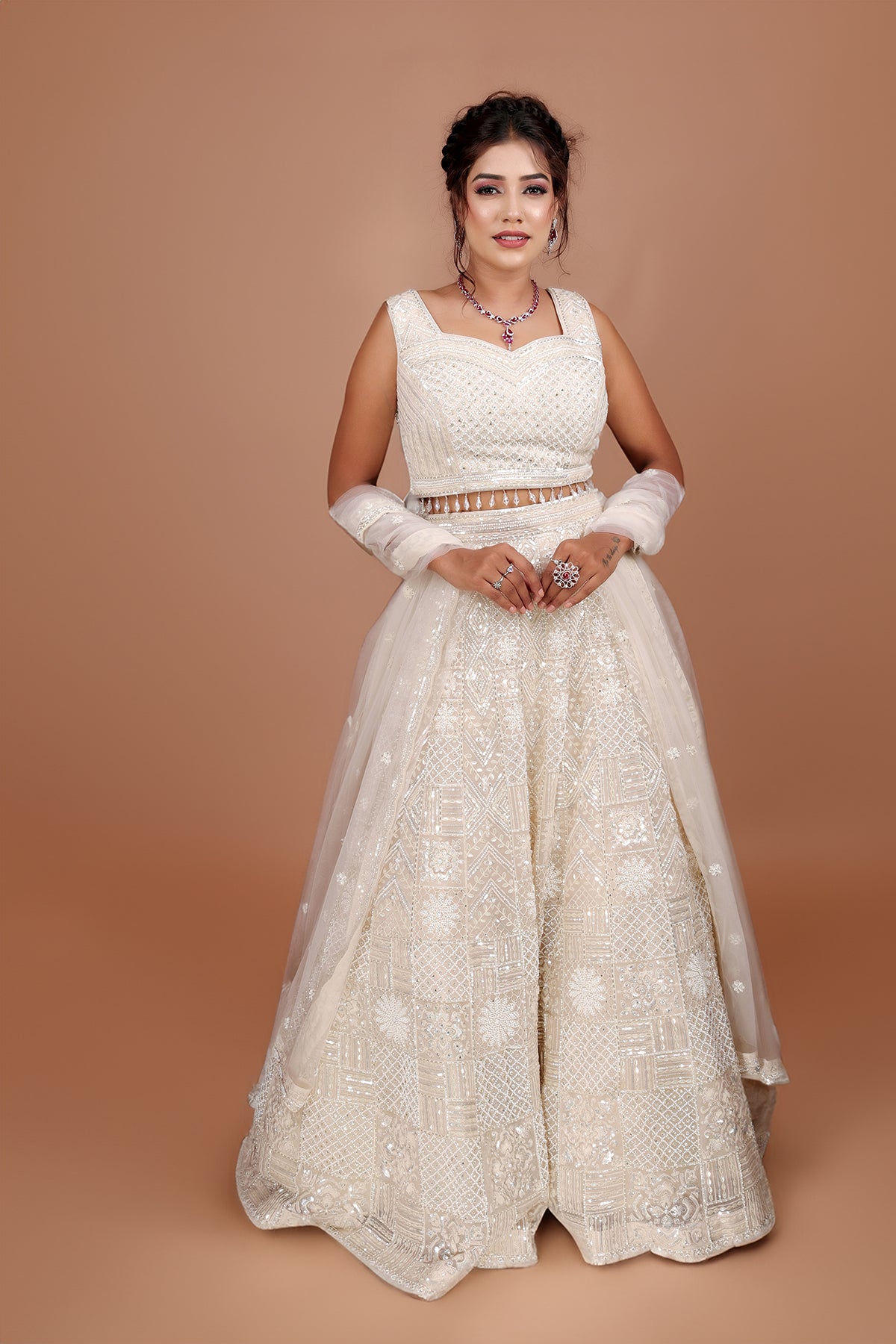 White Lehenga in Net fabric adorned with thread, pearl and cut dana embroidery