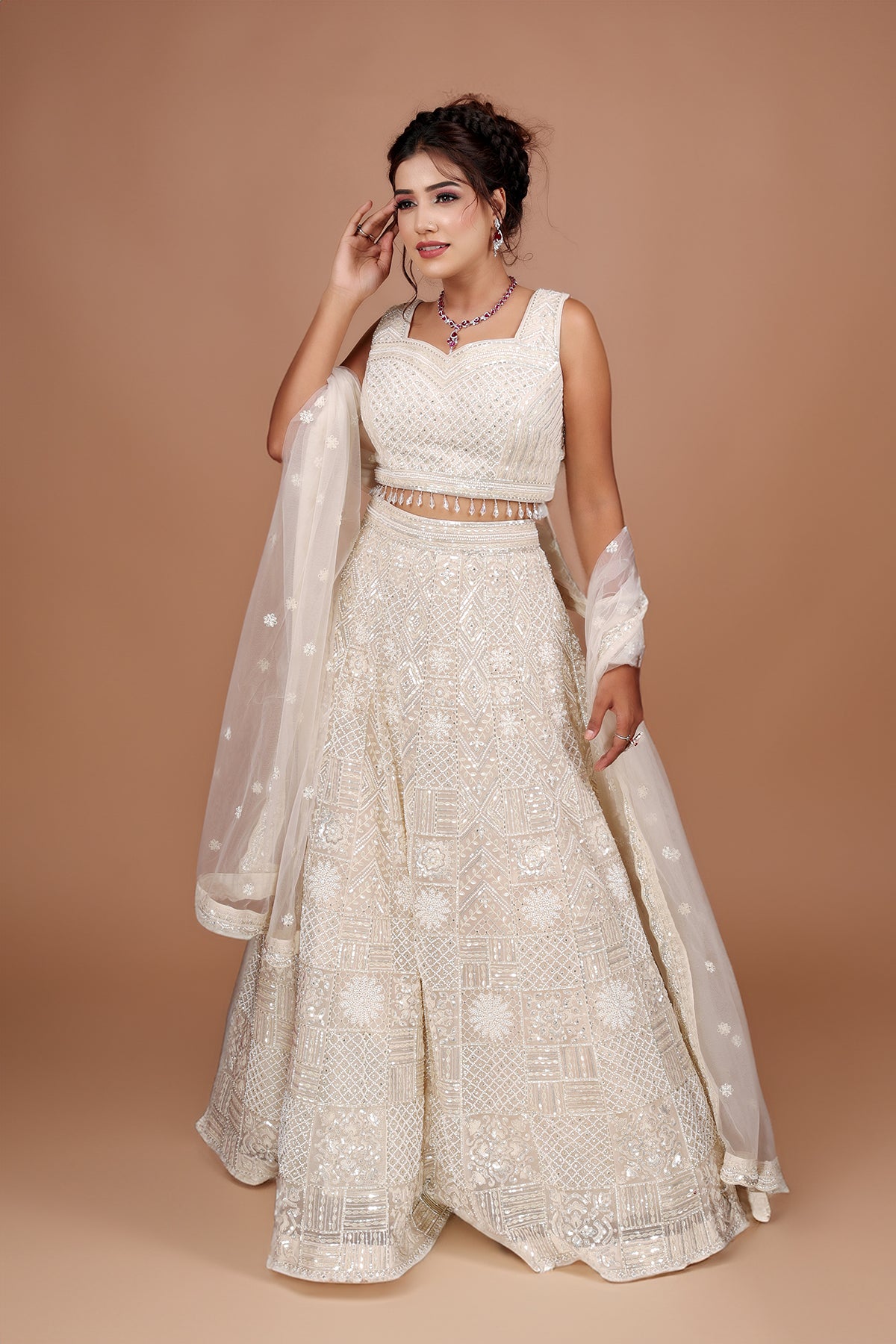 White Lehenga in Net fabric adorned with thread, pearl and cut dana embroidery