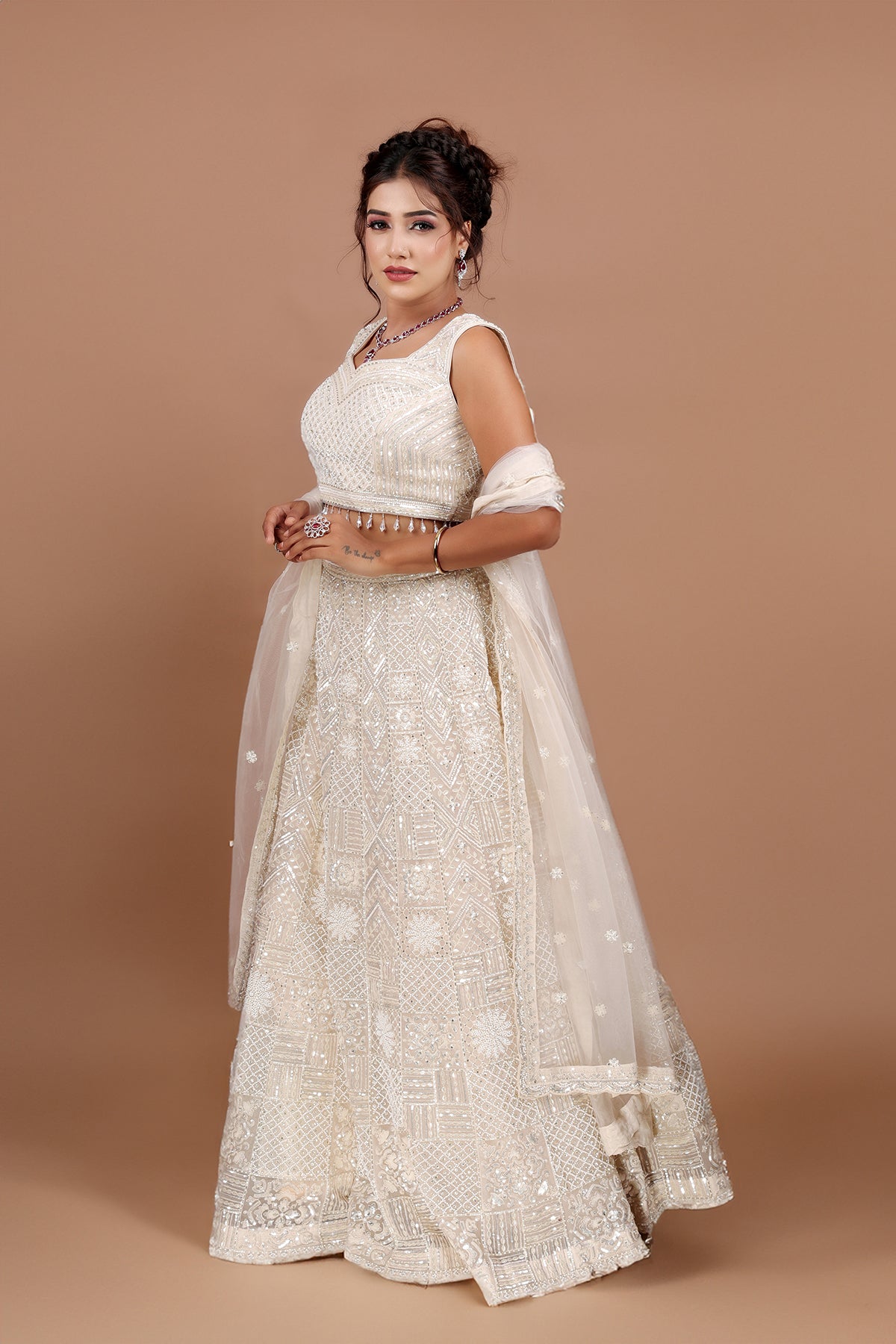 White Lehenga in Net fabric adorned with thread, pearl and cut dana embroidery