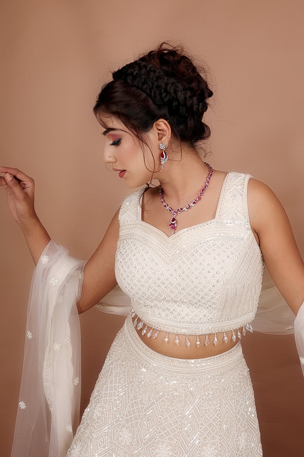 White Lehenga in Net fabric adorned with thread, pearl and cut dana embroidery