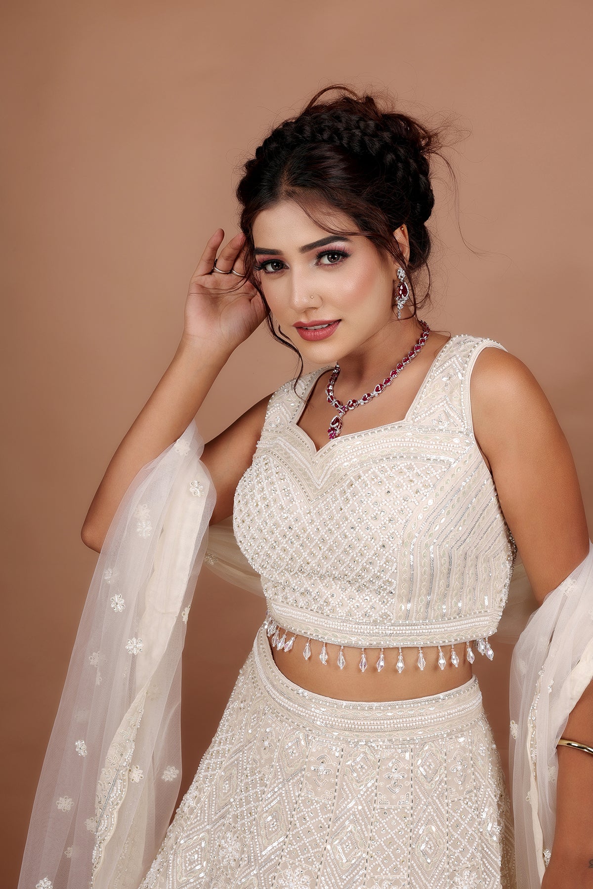 White Lehenga in Net fabric adorned with thread, pearl and cut dana embroidery