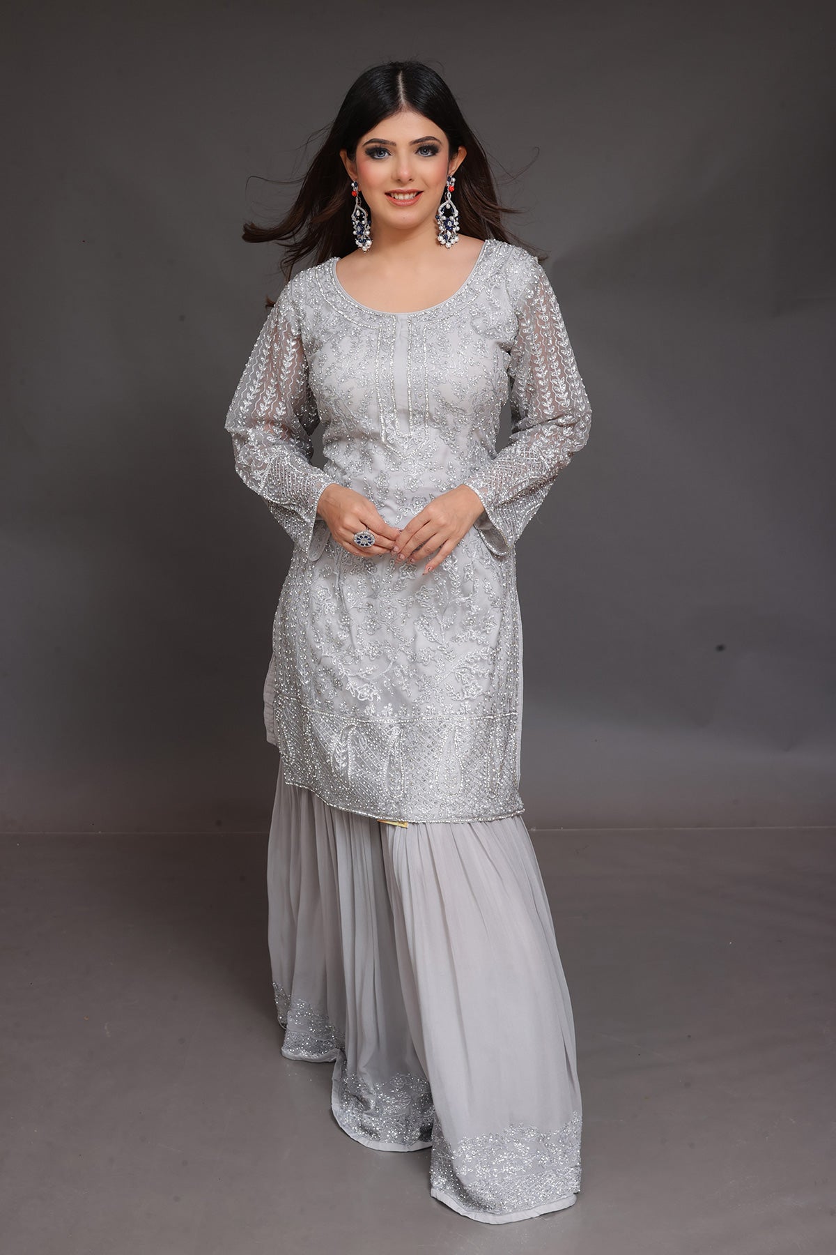 Grey Sharara suit embellished with hand embroidery in Net