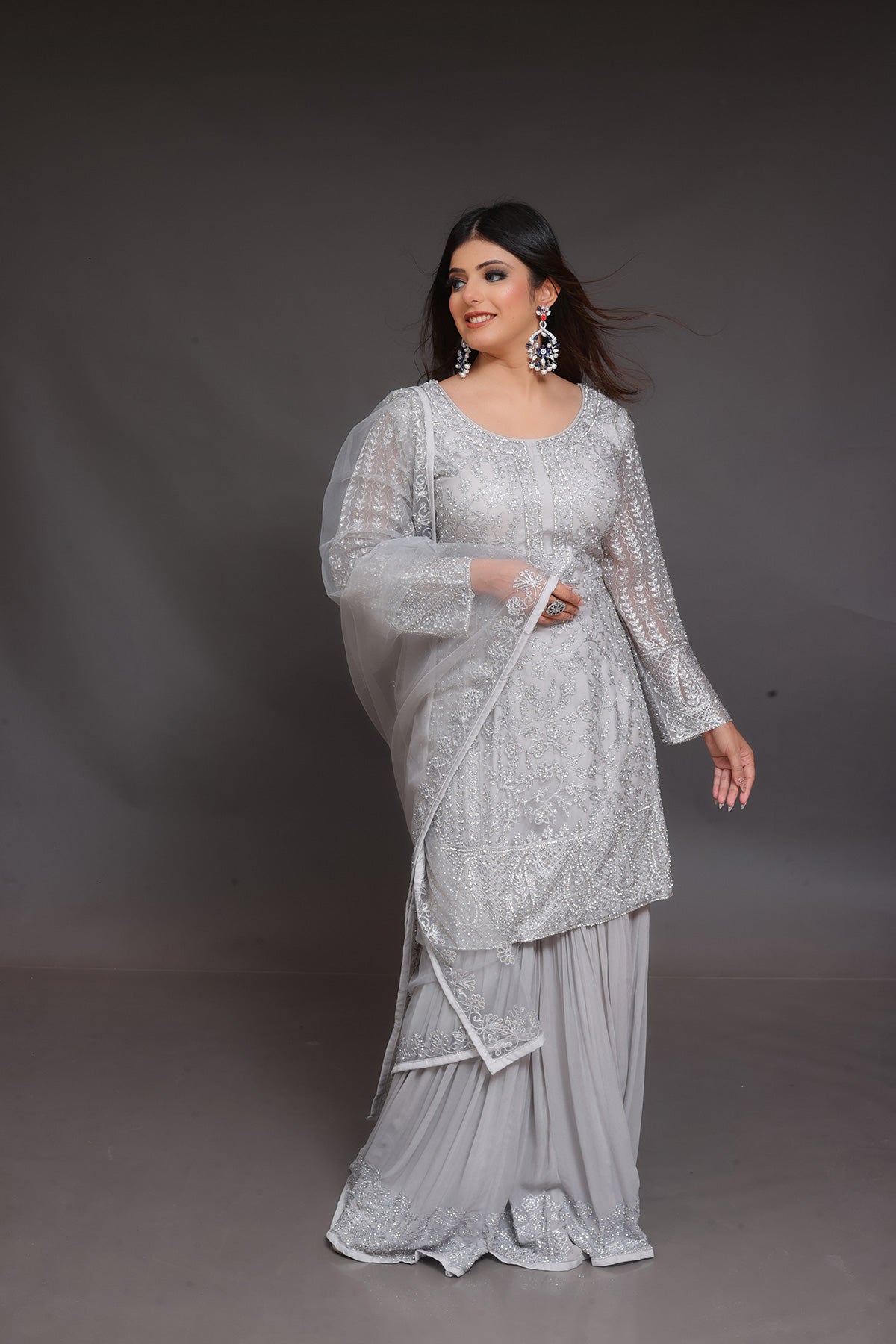 Grey Sharara suit embellished with hand embroidery in Net