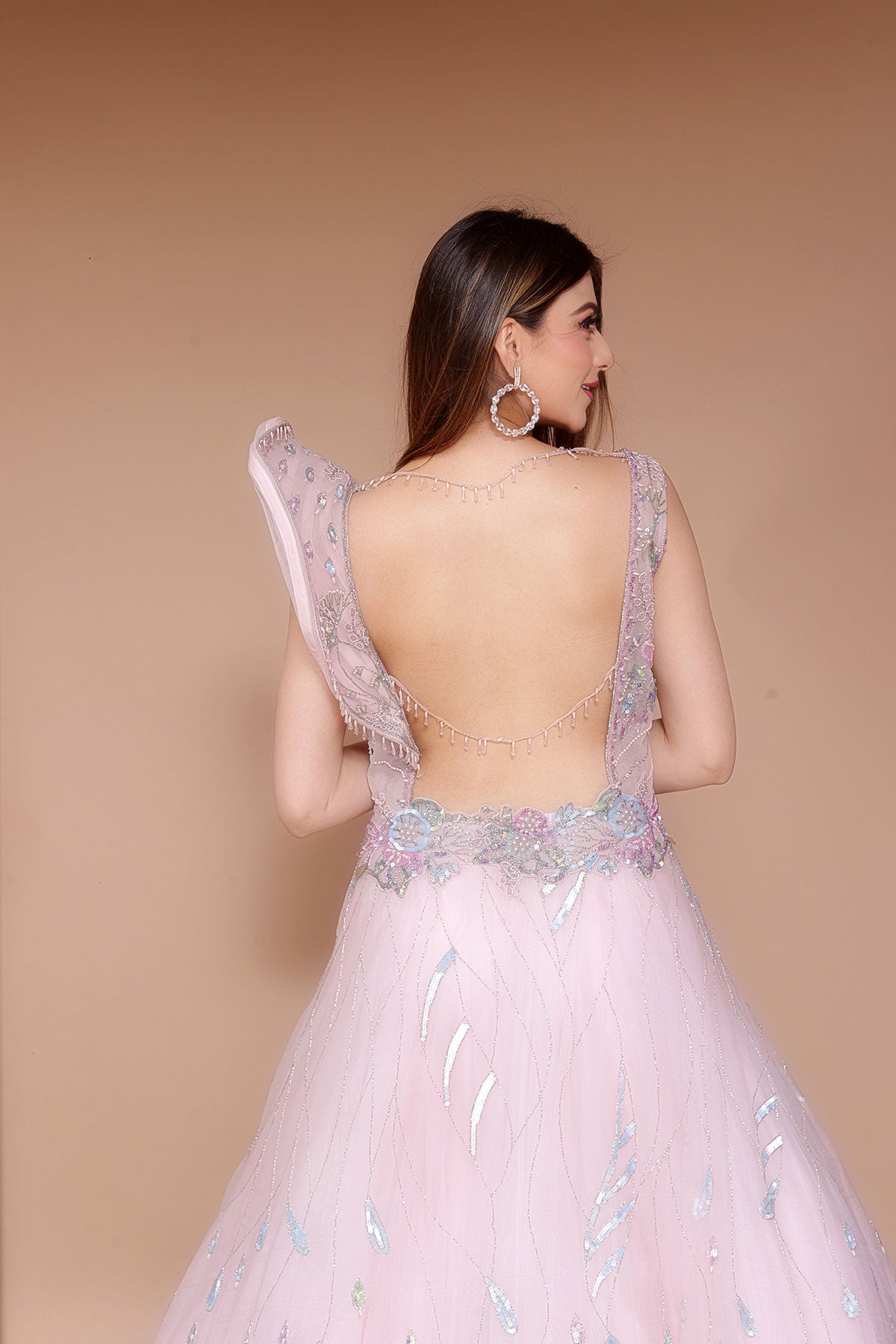 Baby Pink Gown in Net embellished with hand embroidery on yolk along with cape sleeve