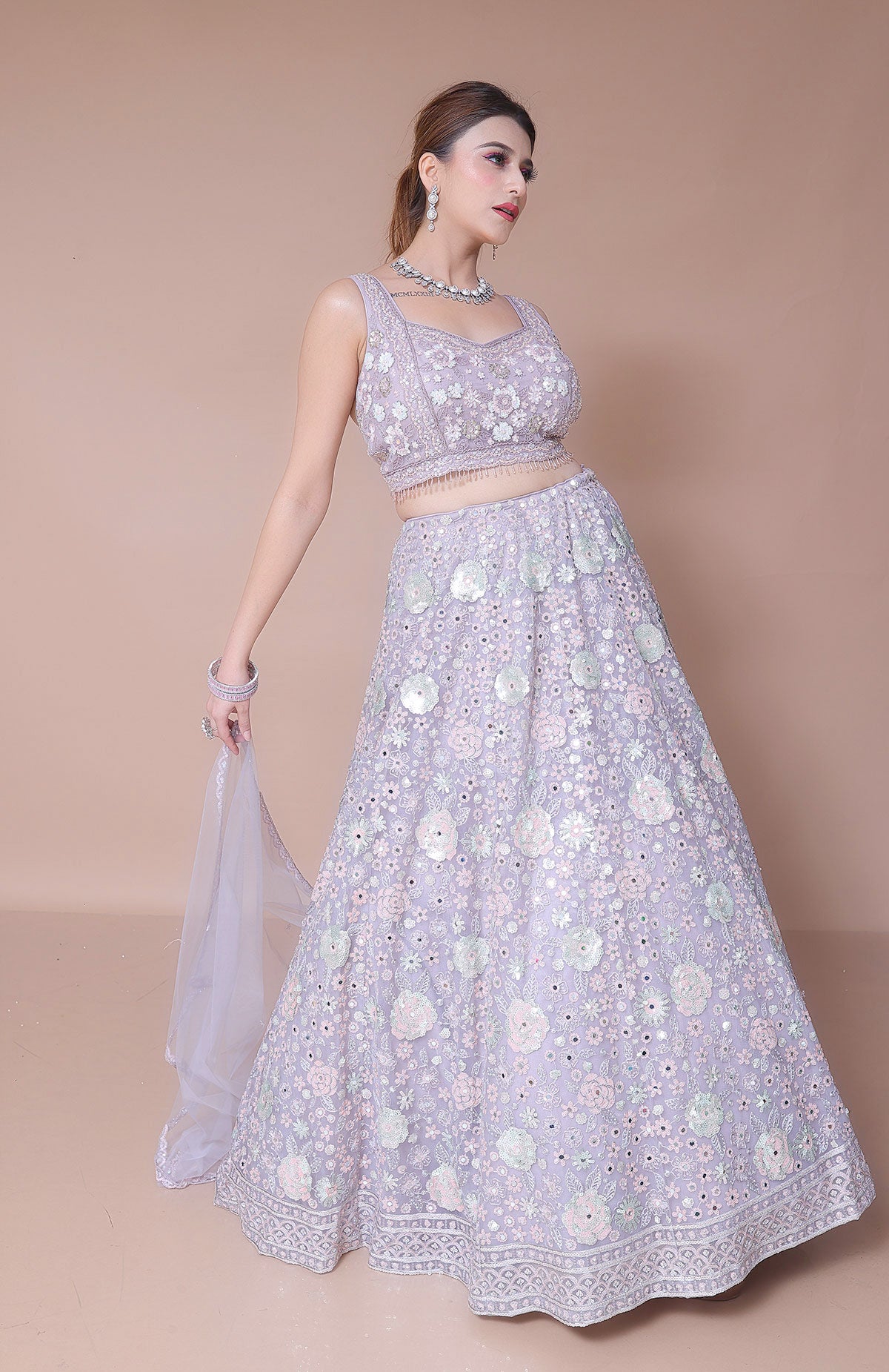 Lavender Lehenga Choli in Net embellished with hand embroidery