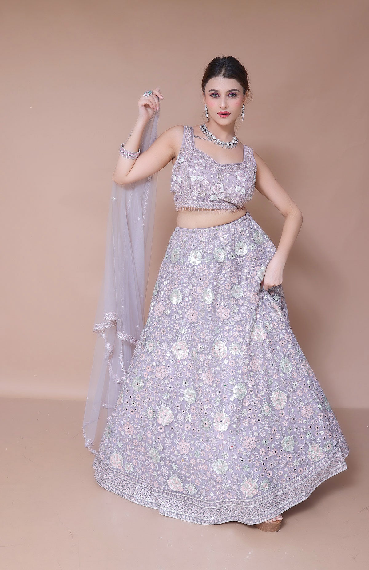 Lavender Lehenga Choli in Net embellished with hand embroidery