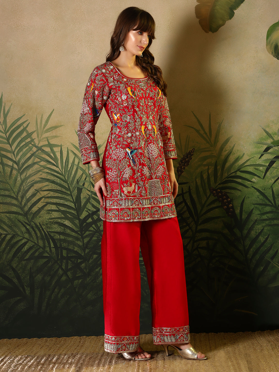 Vibrant red suit, adorned with intricate bird and floral embroidery