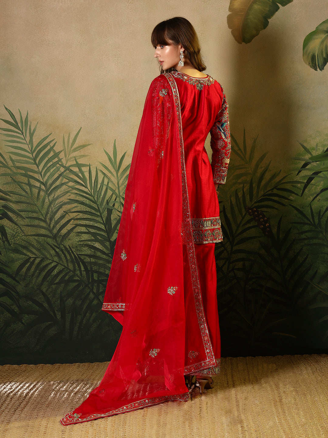 Vibrant red suit, adorned with intricate bird and floral embroidery